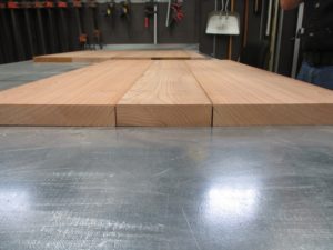 three boards of redwood that are plained down and lined up to be glued together