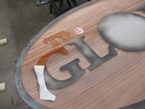 the redwood sign has been sandblasted and now we are ready to peal off the protective rubber mask