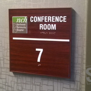 conference room sign with raised logo and copy and grade II braille rastors