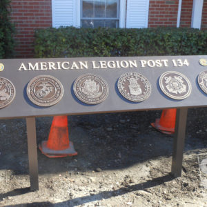 custom fabricated sign with custom cast us armed forces logos pin mount to sign