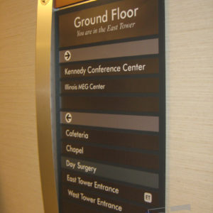 custom wayfinding sign with brushed aluminum cured detail and suite inserts