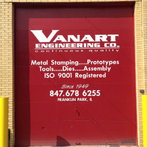 exterior garage door with white vinyl graphics