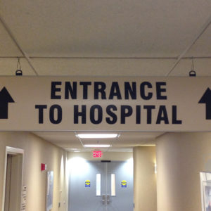 hanging curved frame, wayfinding signage in hospital hallway