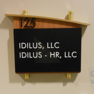 room plaque with wood finish, gold stand-offs and removable tenant insert